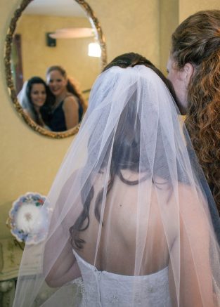 Bride and her mother looking into a mirror
