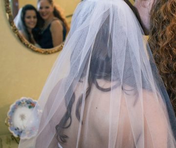 Bride and her mother looking into a mirror