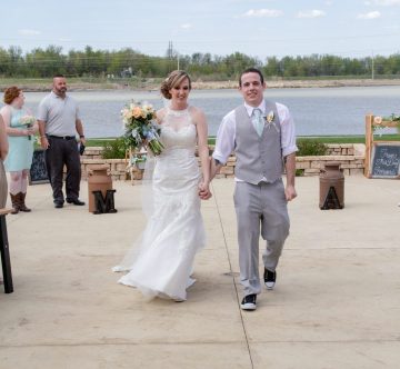 bride and groom recessional with river behind them