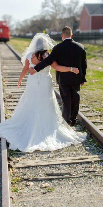 Bride and Groom from behind on train tracks