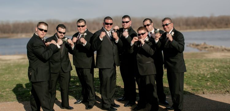 Groom and groomsmen with fists up and sunglasses on