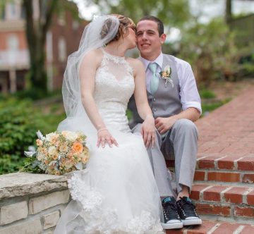 the bride and groom sitting on steps together