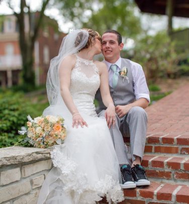 the bride and groom sitting on steps together