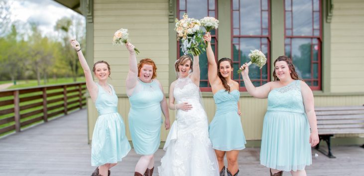 bridal party holding bouquets up