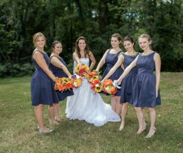 Bride and bridesmaids showing off bouquets