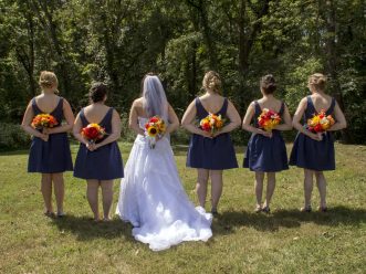 bridal party holding bouquets behind their backs