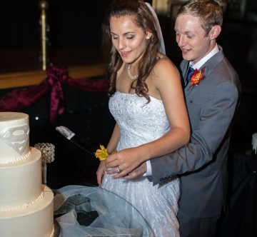 Bride and Groom cutting Superman cake