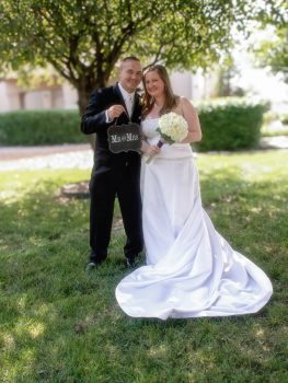 bride and groom holding Mr & Mrs sign