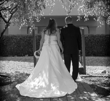 bride and groom from behind in black and white