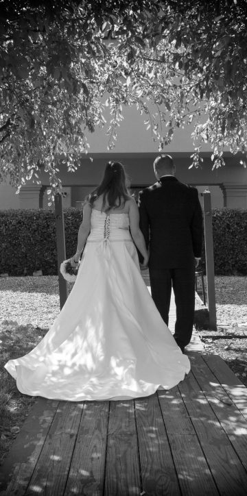 bride and groom from behind in black and white