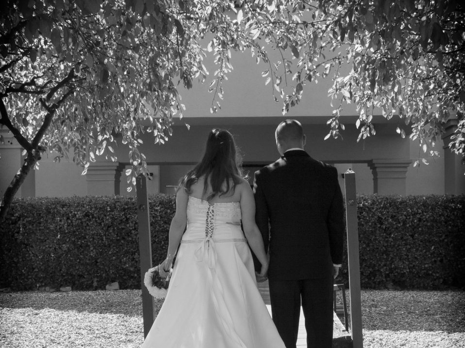 bride and groom from behind in black and white